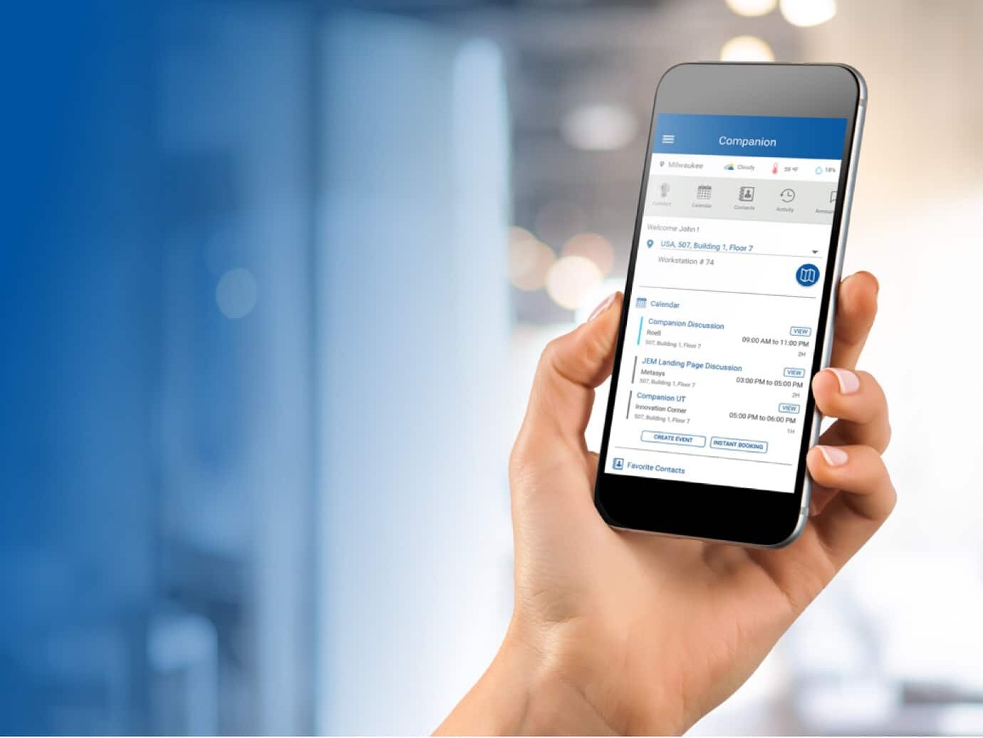 Close-up of a person holding a phone displaying OpenBlue Companion app