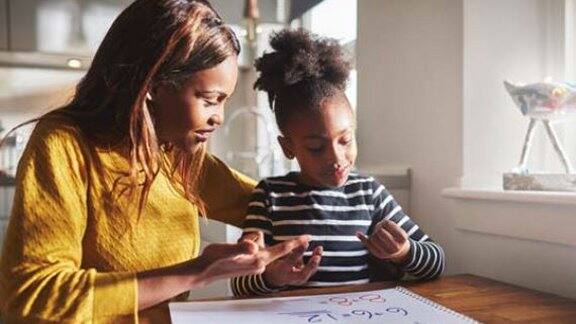 mom teaching daughter to calculate