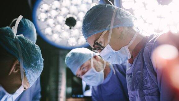 surgeon performing surgery with her team
